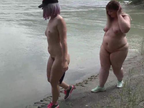Lesbians nudists walk across the river bank with anal plugs in a big asses.  fetish